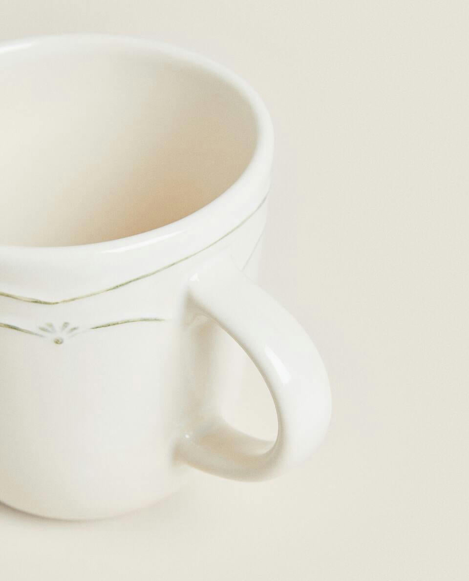 EARTHENWARE MUG WITH RAISED CHRISTMAS DESIGN